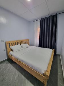 a bed in a room with a black curtain at Nyumbani Kivu Retreat in Rubavu