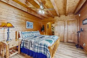 een slaapkamer met een bed in een blokhut bij Fox Hollow in Little Cove +24 foto's