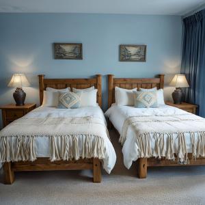 two beds sitting next to each other in a bedroom at Mountain Sky Stay in Aspen