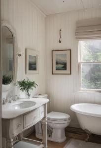 a white bathroom with a sink and a tub and a toilet at Mountain Sky Stay in Aspen
