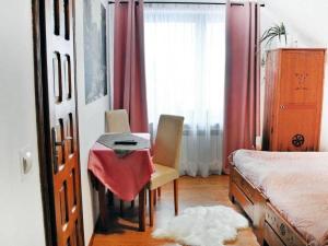 a bedroom with a table and chairs and a bed at Salamonówka in Szlachtowa