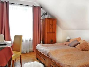a bedroom with a bed and a desk and a window at Salamonówka in Szlachtowa +4 photos