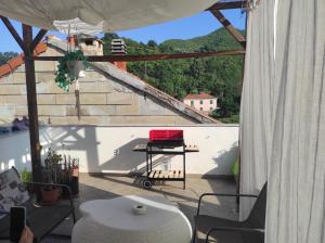 a view of a patio with a table and stairs at La casa di Jeannette in Vado Ligure