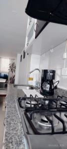 a kitchen stove top with a coffee pot on it at Apartamento Limón Azul in Sogamoso