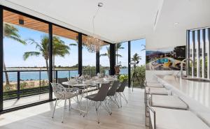 パーム・ビーチ・ショアーズにあるCozy Three-Bedroom Waterfront Apartment with Scenic Viewsのテーブルと椅子と海のあるダイニングルーム +11枚の写真