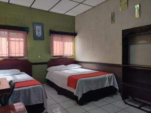 Ένα ή περισσότερα κρεβάτια σε δωμάτιο στο Hotel en Santa Ana