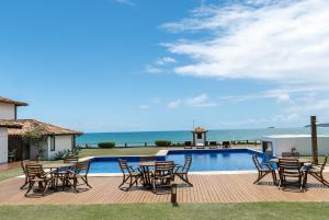Casa em Buzios Proxima da Praia - BRD2 في بوزيوس: سطح بطاولات وكراسي بجانب مسبح
