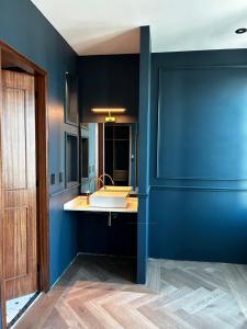 a bathroom with a sink and a blue wall at The Sapphire View Suite in Mexico City
