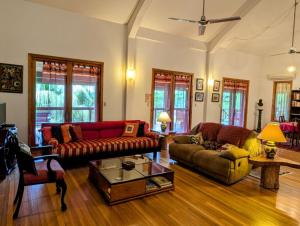 a living room with two couches and a coffee table at Framadani estate entire property - 3BDR Villa with pool and 1BDR Cabin in San Ignacio