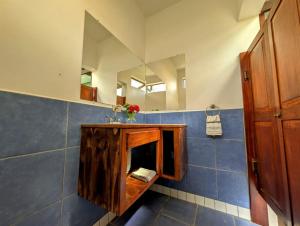 a bathroom with a sink and a mirror at Palapa Ix-Chel - Unique bungalow in San Ignacio +26 photos