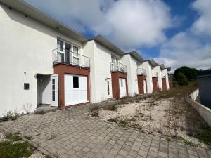 a row of white buildings with balconies on them at Work & Travel Lodge Münsingen in Münsingen