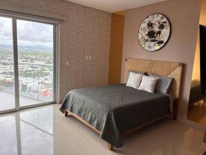 a bedroom with a bed with a clock on the wall at Alojamiento de Lujo a Pie de Playa By GPSRentas in Isla Venados +54 photos