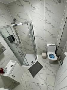 a white bathroom with a shower and a toilet at Central London room w kitchen in London