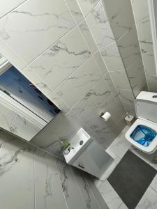 a white bathroom with a sink and a toilet at Central London room w kitchen in London