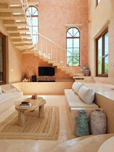 a living room with a staircase and a table at Tuscan Breeze, Nandi Hills in Nandigunda