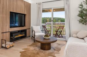 a living room with a fireplace and a tv at Pond House at Carter Bridge Estate in Freehold
