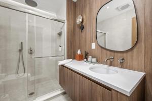a bathroom with a sink and a shower and a mirror at Pond House at Carter Bridge Estate in Freehold +32 photos