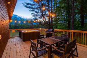 a wooden deck with a table and chairs and a grill at Pond House at Carter Bridge Estate in Freehold