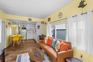 a living room with a couch and a table at Beautiful Decorated Cozy Retreat in Rockaway Beach