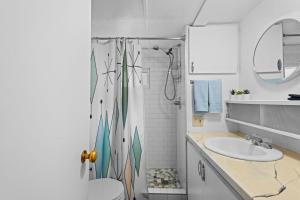 a bathroom with a shower and a toilet and a sink at Beautiful Decorated Cozy Retreat in Rockaway Beach +19 photos