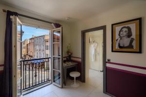 a room with a balcony with a view of a building at Hôtel de Paris Saint-Tropez in Saint-Tropez