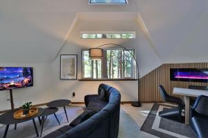 a living room with a couch and a table at Hidden Dome Retreat in the Trees in Barview