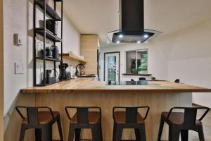 a kitchen with a counter with four chairs at it at Hidden Dome Retreat in the Trees in Barview