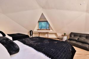 a bedroom with a large bed and a couch at Hidden Dome Retreat in the Trees in Barview