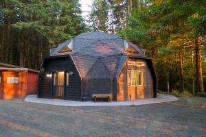 a small cabin with a dome on top of it at Hidden Dome Retreat in the Trees in Barview