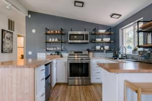 a kitchen with a stove and a microwave at Crown Point Hideaway in Crown Point