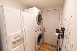 a kitchen with a refrigerator and a washer and dryer at Crown Point Hideaway in Crown Point