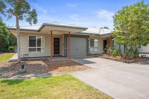 a house with a driveway in front of it at Charming 2BR Home in Serene Mount Warren Park in Windaroo
