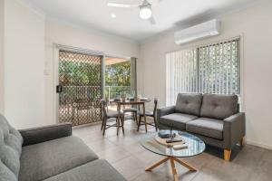 a living room with a couch and a table at Charming 2BR Home in Serene Mount Warren Park in Windaroo