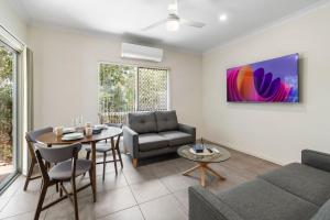 a living room with a couch and a table at Charming 2BR Home in Serene Mount Warren Park in Windaroo