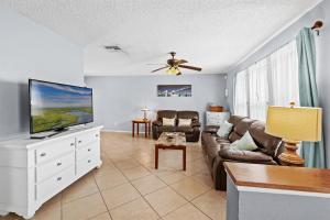 a living room with a couch and a flat screen tv at Florida Flair Villa in Cape Coral Hospital Heliport