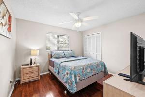 a bedroom with a bed and a ceiling fan at Florida Flair Villa in Cape Coral Hospital Heliport +33 photos