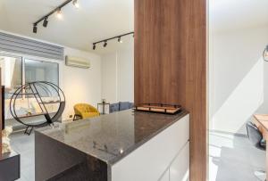 a kitchen with a counter top in a room at Curl 2-Bedroom Apartment in Gemmayzeh in Ar Rumayl +4 photos
