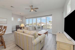 a living room with a couch and a tv at Funky Fish House Villa in Shell Point Village