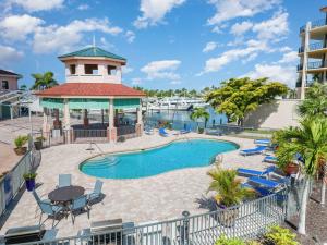 a resort pool with a gazebo and a marina at Funky Fish House Villa in Shell Point Village