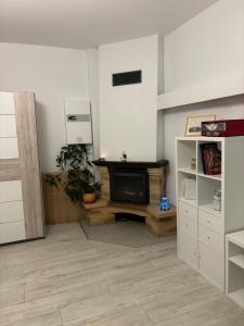 a living room with a fireplace and a television at Vecpilsētas apartaments in Cēsis