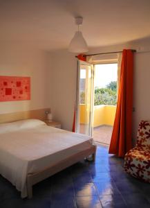a bedroom with a bed and a sliding glass door at Belvedere in Procida