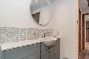 a bathroom with a sink and a mirror on the wall at Muriau-Bach in Dolbenmaen +23 photos