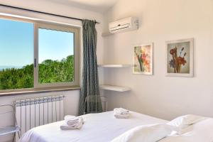 Giường trong phòng chung tại Villa Paradiso