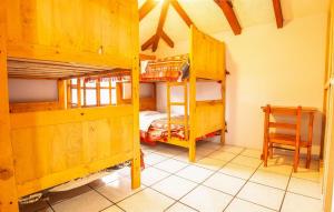 a room with two bunk beds and a table at Casa del Huesped in Otavalo