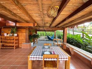 a patio with a table and chairs on a deck at Wang Namthip Hotel in Muang Fuang