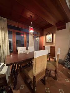 a dining room with a wooden table and chairs at Sa Torre in Campos