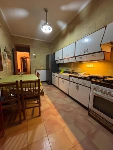 a kitchen with white cabinets and a table in it at Sa Torre in Campos +10 photos