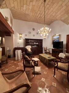 a living room filled with furniture and a chandelier at Sa Torre in Campos