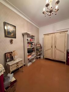 a living room with a chandelier and a room with a table at Sa Torre in Campos
