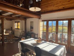 a dining room with a table and some windows at South-facing Chalet With Views in Le Villard-Late +20 photos